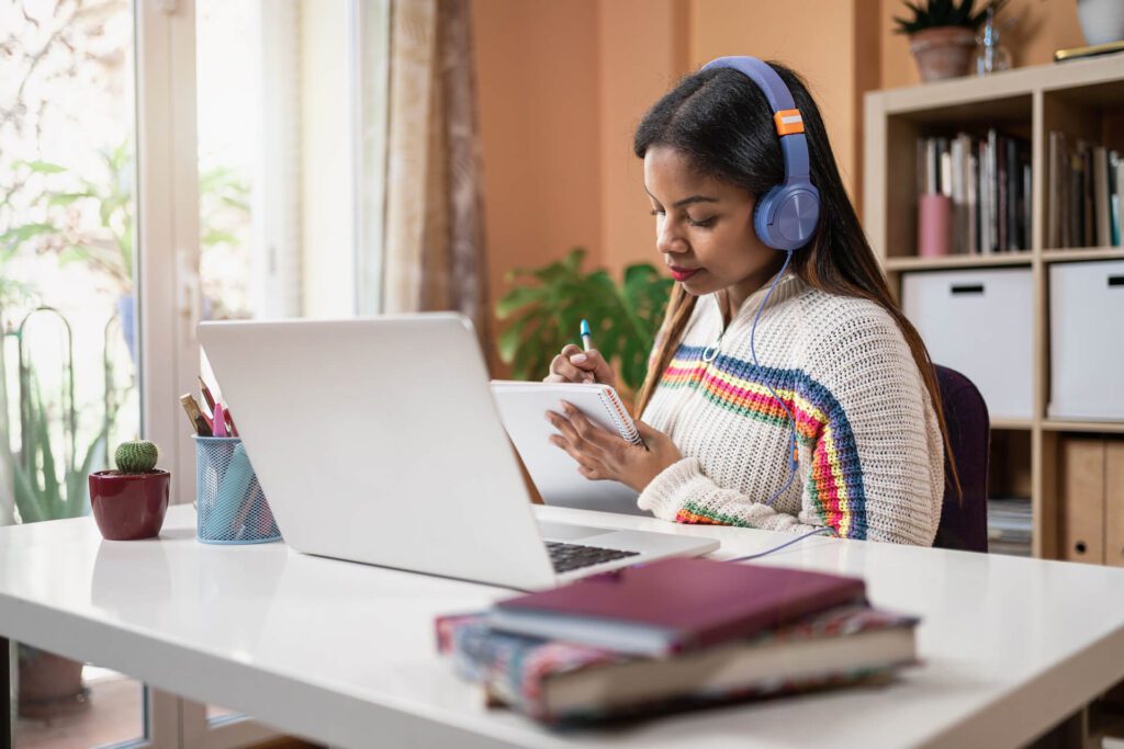 Girl with headphones working on computer